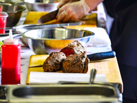 Cooked Roast Beef On a Cutting Board. Cooking Master Class, Workshop with People Learning How to Cook Around the Tableの写真素材