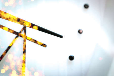 Black Hands on White Clock Face. Golden Celebration Lights Reflections. Holiday, Festivity, Party...