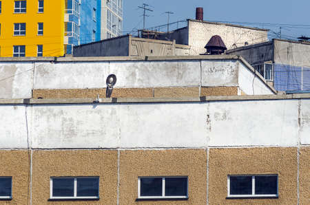 Development in Tight Urban Spaces. Chaotic Rooftops of Various Buildings with Web of Cable Wire Lines, TV Antennas, Concrete Slabs, Brickwork.の写真素材