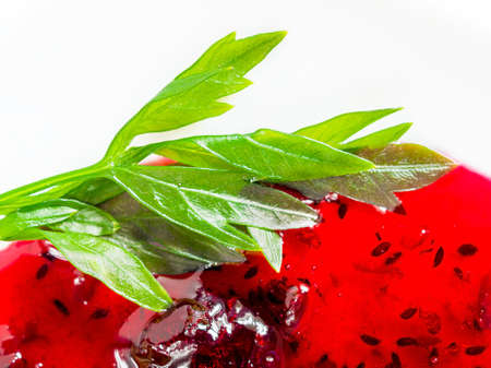 Leaves of Garden Parsley, Petroselinum Crispum, and Currant Jam on White Plate.の写真素材