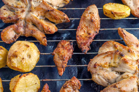 Roasted Potatoes and Chicken Slices on Stainless Steel Cooking Grid. Grilled Chicken Breast with Slices Made for Marinade to Penetrate the Meat Better, and Ensure Chicken Cooked Evenly.の写真素材