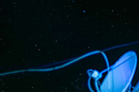 Blurred Satellite Antenna Dish, Cables, on Starry Sky Background.の写真素材