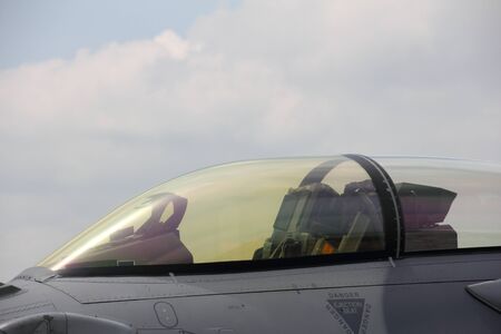 A close up side view of a fighter jet's cockpit