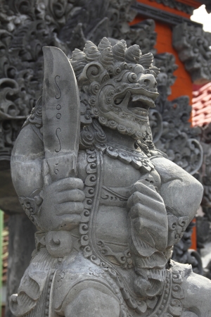The side view of a Balinese statue found outside a Balinese templeの写真素材