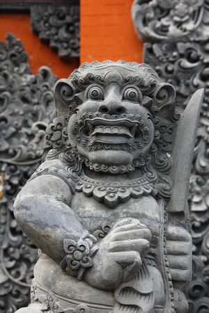 The front view of a Balinese statue found outside a Balinese templeの写真素材