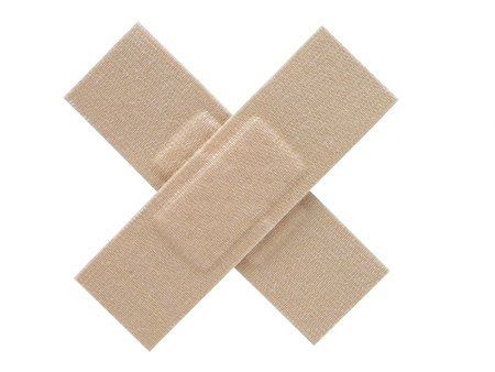 Two cloth plasters placed together to form a cross  Isolated on a white background の写真素材
