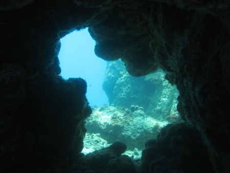 Exit of an underwater cavern. Looks out into open water.の写真素材