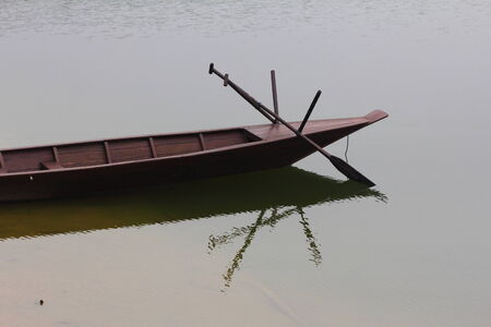 Sampan or flat-bottomed Chinese wooden boat from the side