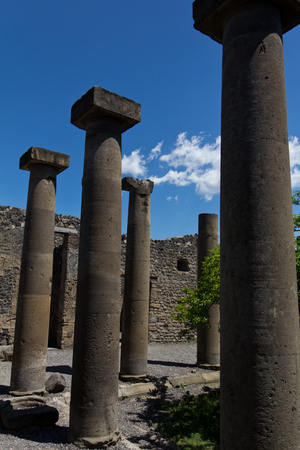 Restored stone columns lining a courtyard in Pompeiiの写真素材