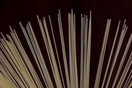 Uncooked angel hair pasta spread out and isolated on black backgroundの写真素材