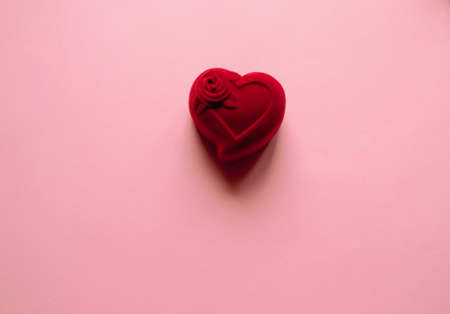 Casket red velvet heart on a pink background, and a red shawl. March 8. The 14th of February