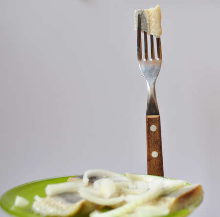 a piece of herring on the forkの写真素材