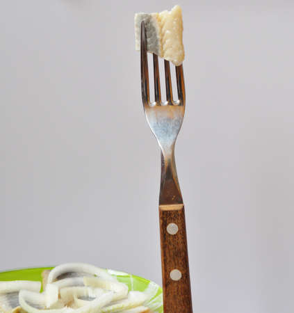 a piece of herring on the forkの写真素材