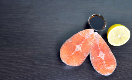 two pieces of fresh fish with lemon and soy sauce
