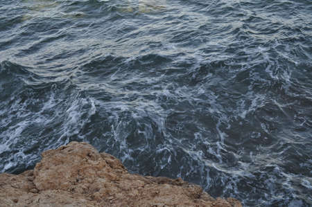 Large stones against the background of the stormy sea