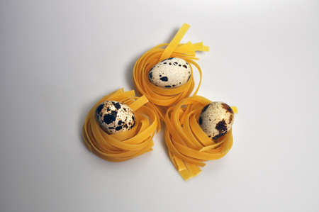 pasta of different types with quail eggs and red pepperの写真素材