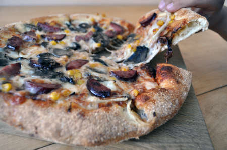 round pizza sour, sausages and vegetablesの写真素材