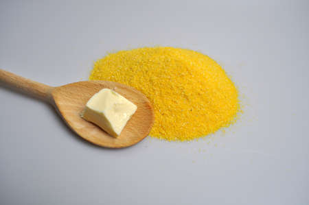 Croup for cooking porridge in a clay plate and a wooden spoon