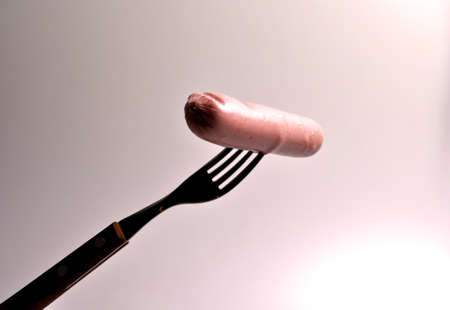 food - three sausages on a gray plate with vegetablesの写真素材