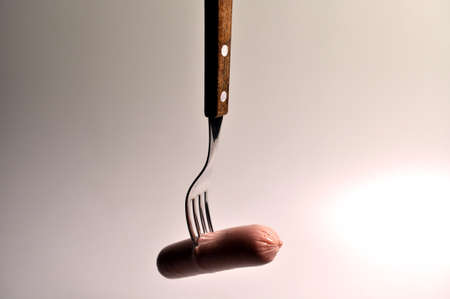 food - three sausages on a gray plate with vegetablesの写真素材