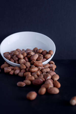 Peanuts in a white plate on the table
