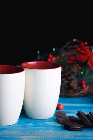 Two New Year's cups with chocolate cookies on the tableの写真素材