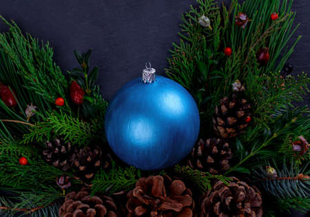 Big Christmas ball with spruce and cones on the tableの写真素材