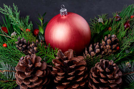 Big Christmas ball with spruce and cones on the tableの写真素材