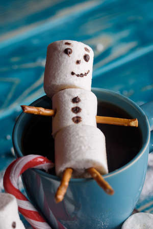 Snowmen from marshmallows. New year snowmen. A festive table made of tea and sweet snowmen.の写真素材