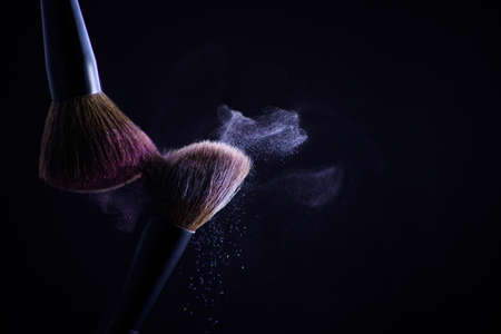 Cosmetic brush for powder on a black background