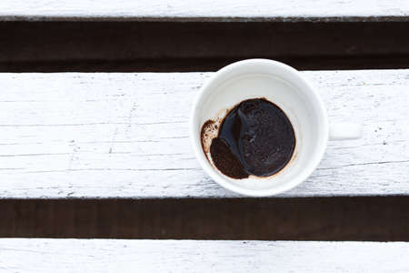 Fragrant coffee in a beautiful cup a cup outside on a wooden table. Spring, breakfast, morning.