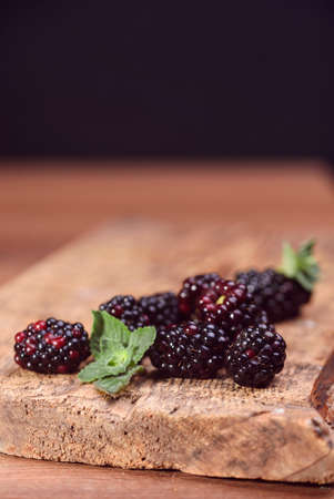 Delicious and healthy blackberry berry, on the table, with a mint leaf