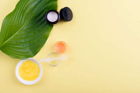 Beautiful layout of cosmetic products on yellow background . Natural cosmetic.place for text . top view . Natural beauty product concept.の写真素材