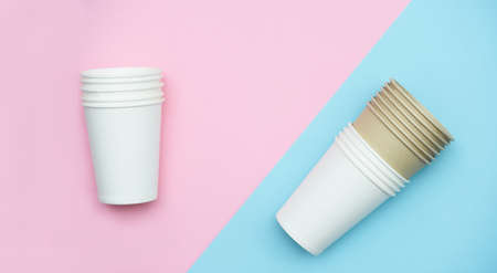 Paper cups for drinks, on a pink and blue background. Plastic replacement