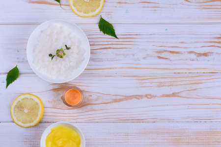 Beautiful layout of cosmetic oils on a wooden background. Natural cosmetics for face and body with citrus notes.の写真素材