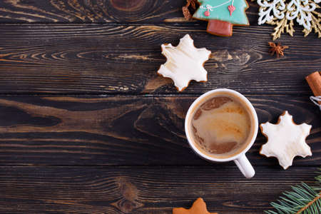 Greeting card for an inscription. Christmas gingerbread cookies, sprig of spruce, cinnamon sticks. Coffee. New Year 2020の写真素材