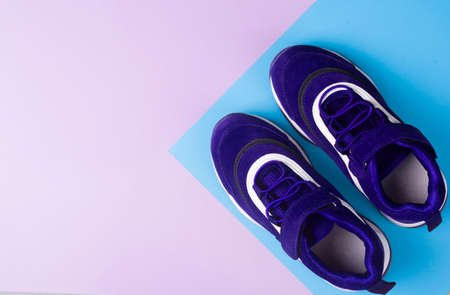 Sports shoes on a colorful background. View from above. Place for text. Flat layの写真素材