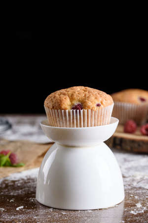 Delicious flavored cupcake with raspberries, white cream, and chocolate icing. Holidaysの写真素材