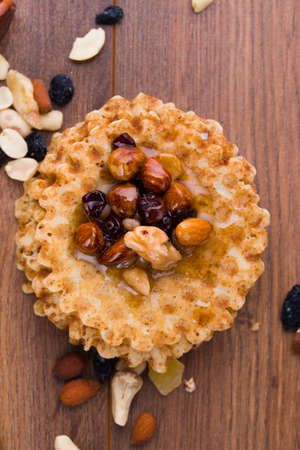 Tasty and healthy honey with nuts on the table. Waffles with honey, homemade sweets.の写真素材