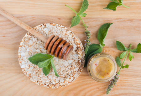 Tasty and aromatic honey in a jar with mint on a wooden table. View from aboveの写真素材