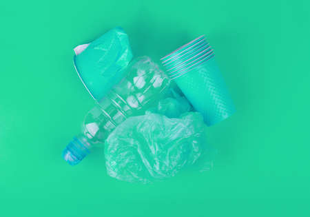 Ecological theme. Plastic glasses and tubes in brightly mint color background .の写真素材