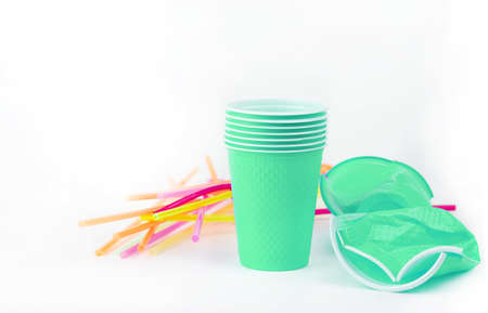 Ecological theme. Plastic glasses and tubes in brightly mint color background .の写真素材