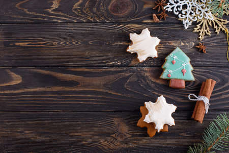 Christmas gingerbread cookies on a wooden background with aromatic coffee and cinnamon sticks. Holidays conceptの写真素材