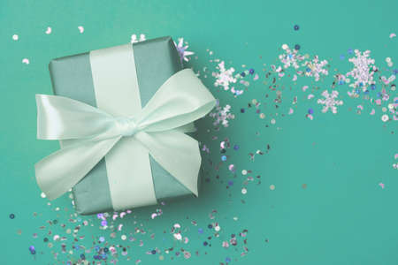 Mint gift box on a beautiful background with a satin ribbon. Holiday concept