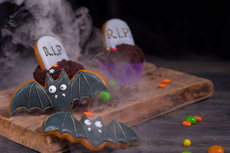 Halloween party content. Halloween cupcakes and colored sweetsの写真素材