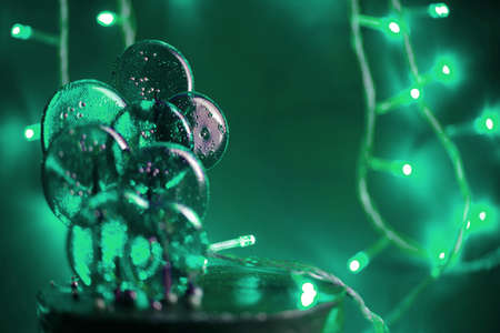 Colourful lollipop with a green tint and lights. Holidays content