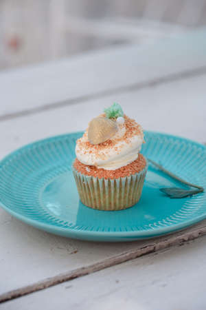 Tasty vanilla cupcakes on wooden board. Food photoの写真素材