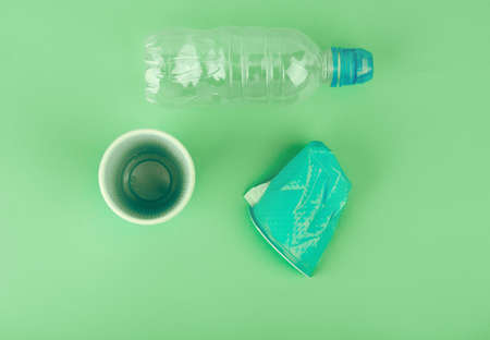 Ecological theme. Plastic glasses and tubes in brightly mint color background .の写真素材