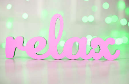 The word relax is gently blue in the background of beautiful lights. New Year's content.の写真素材