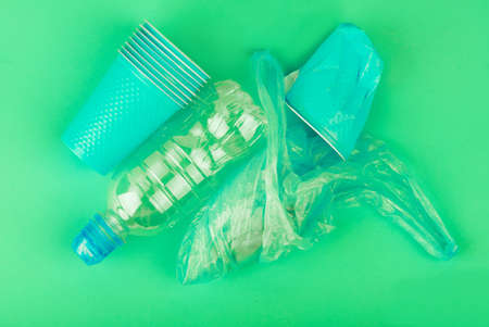Ecological theme. Plastic glasses and tubes in brightly mint color background .の写真素材